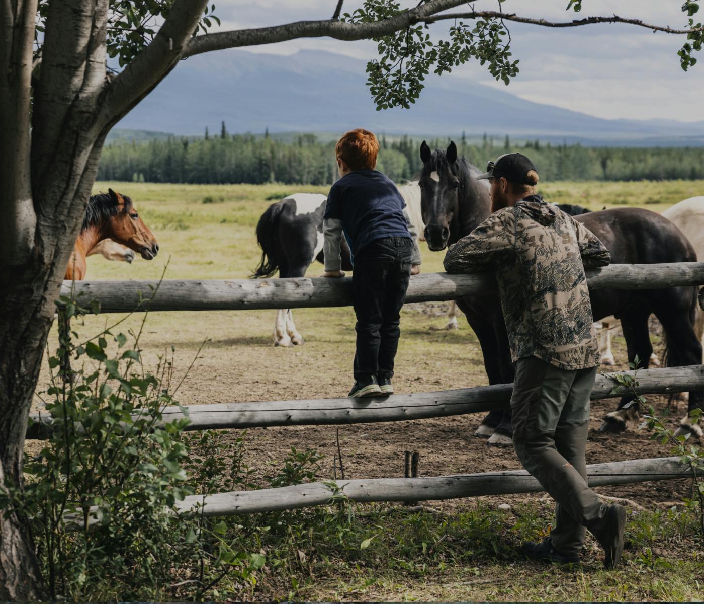Father and son checking in on some horses | SITKA Gear