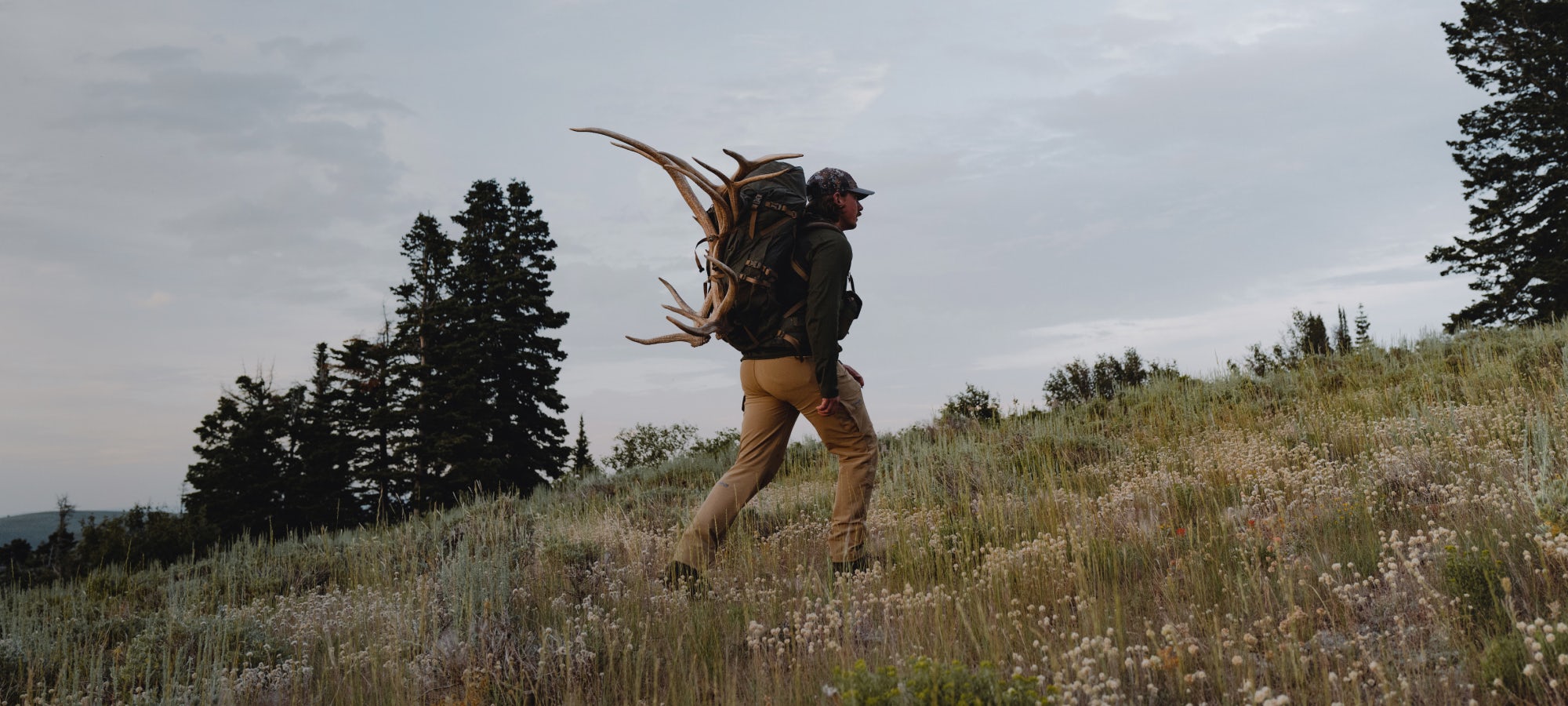 Beau Martonik with the new Mountain Hauler in Deep Lichen packing out elk sheds | SITKA Gear