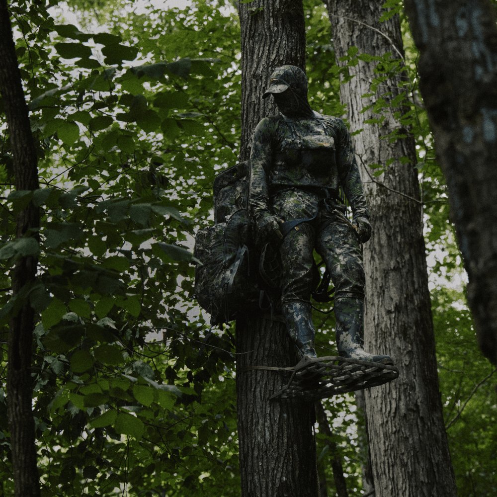 Whitetail hunter in his treestand wearing the Equinox Guard Collection in Optifade Cover | SITKA Gear