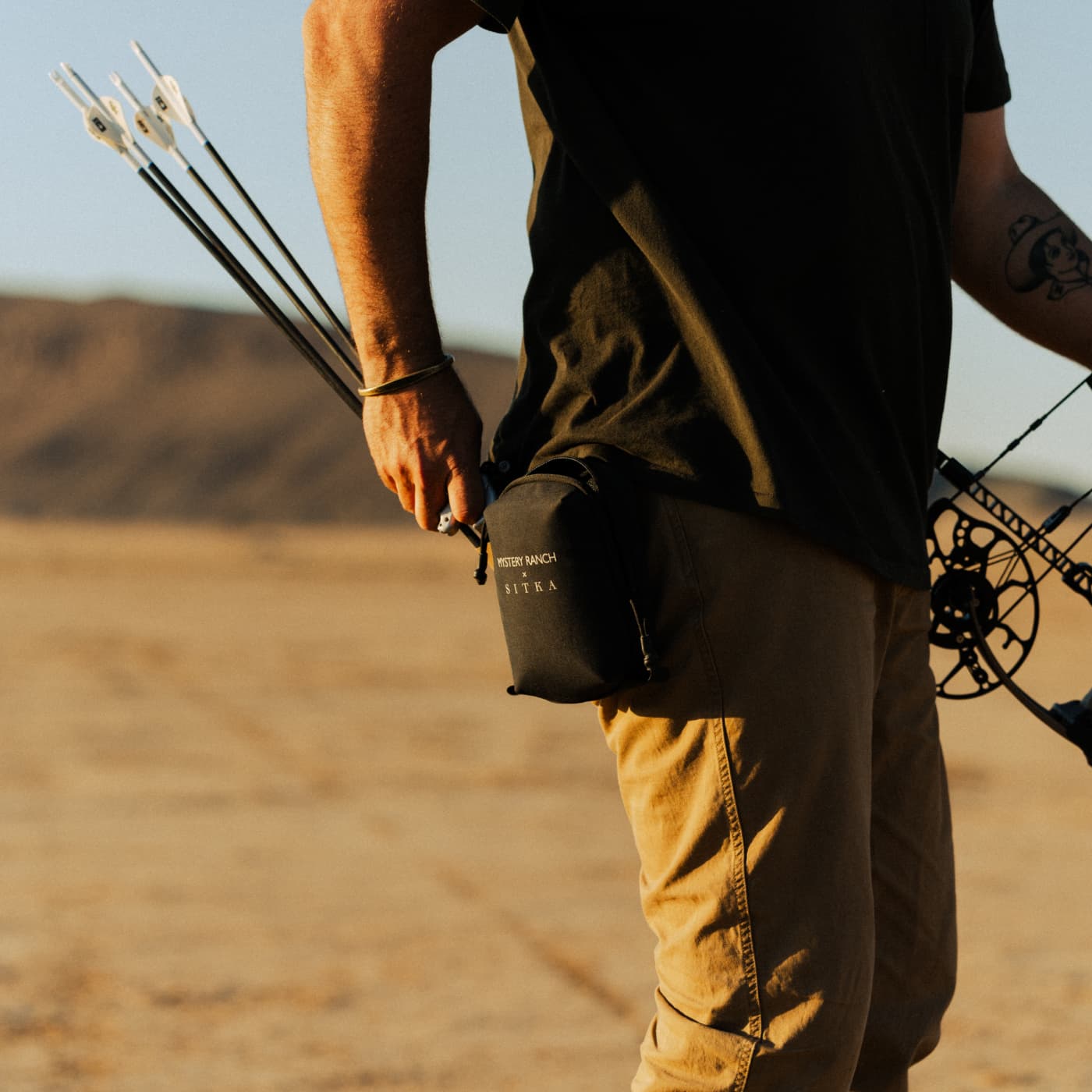 Brad Christian reaching for his release in the Mystery Ranch x SITKA Range Bag | SITKA Studio