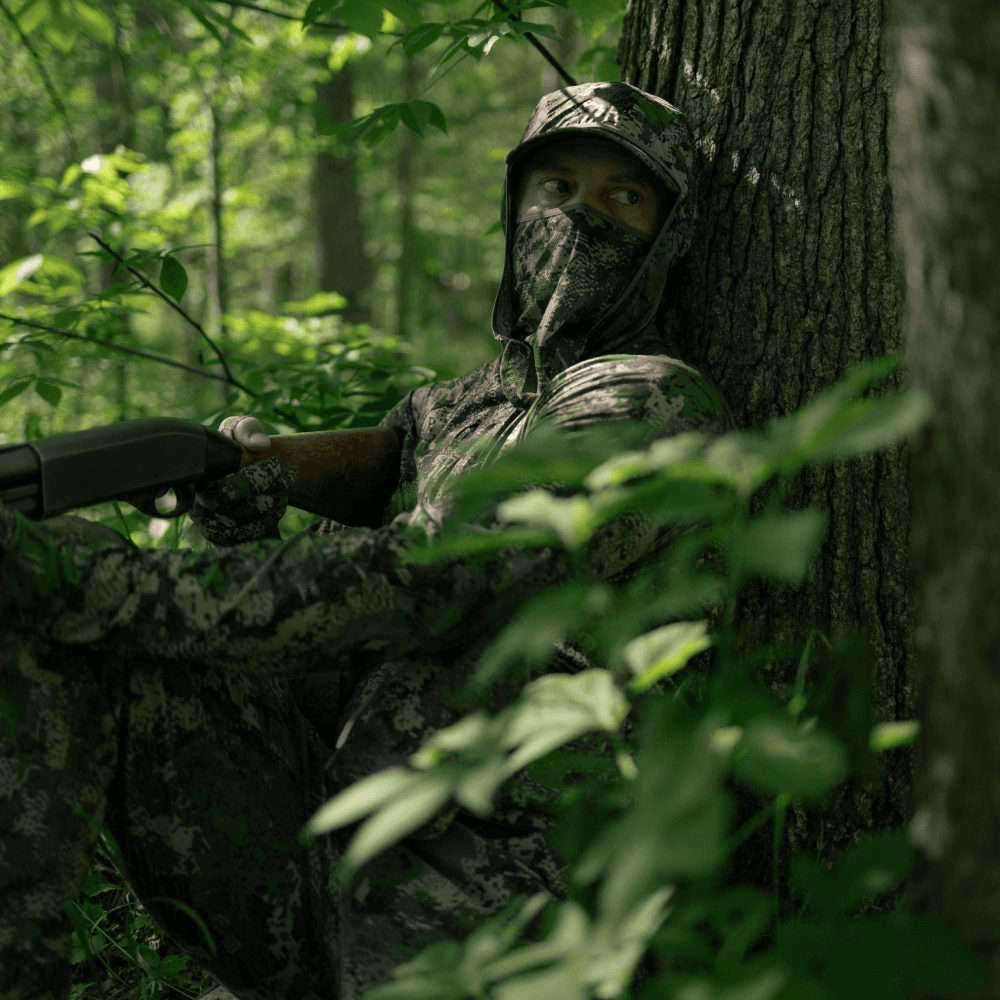 Man waiting for prey while turkey hunting in Equinox Guard gear