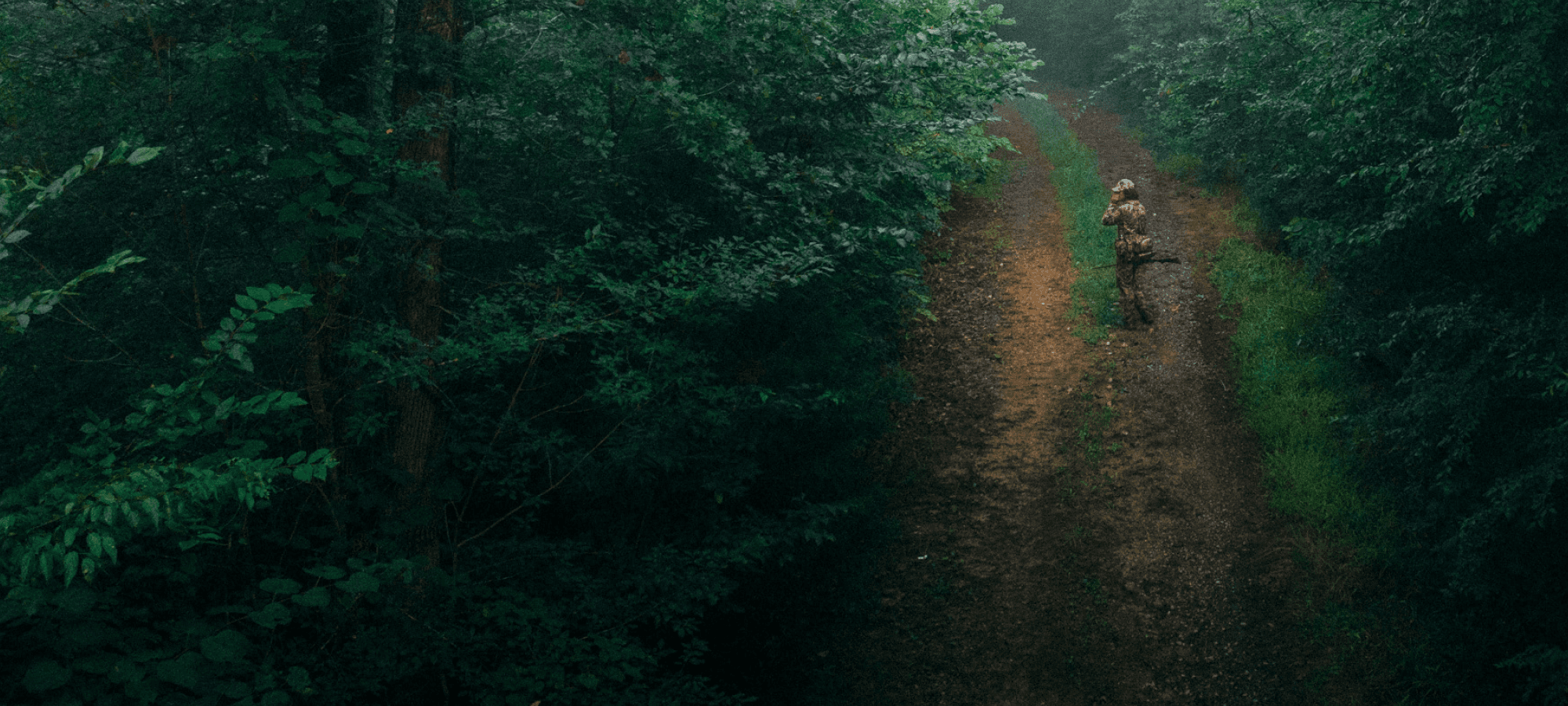 Beau Brooks walking down a dirt road turkey calling with the Turkey Tool Belt | SITKA Gear