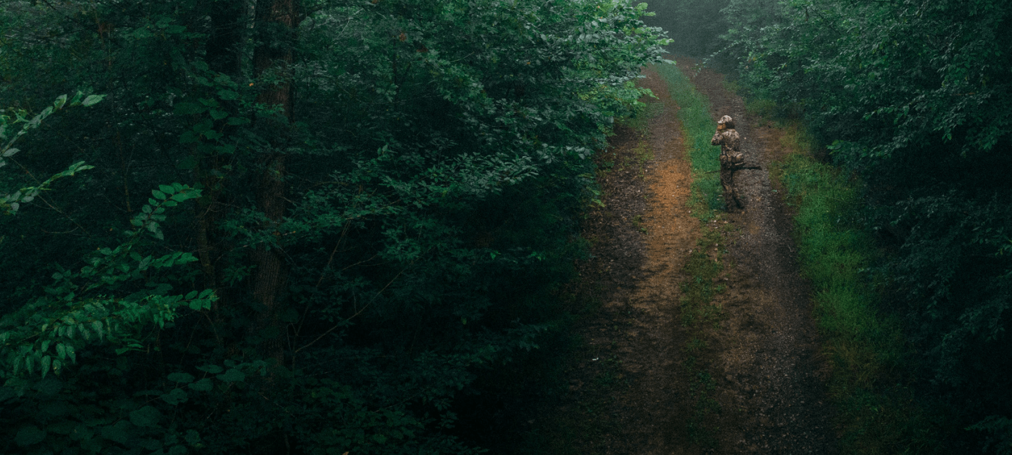 Beau Brooks walking down a dirt road turkey calling with the Turkey Tool Belt | SITKA Gear