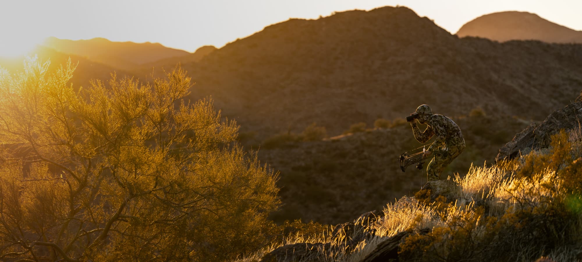 Man stalking mule deer in the Intercept Collection in Optifade Suablpine | SITKA Gear