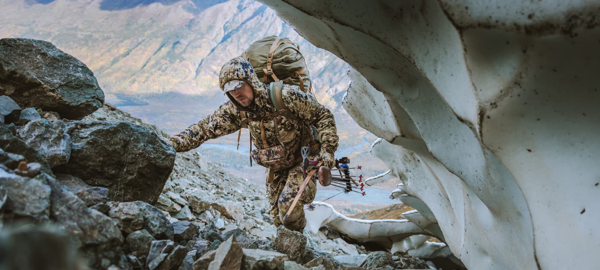 Man trekking up mountain | SITKA Gear