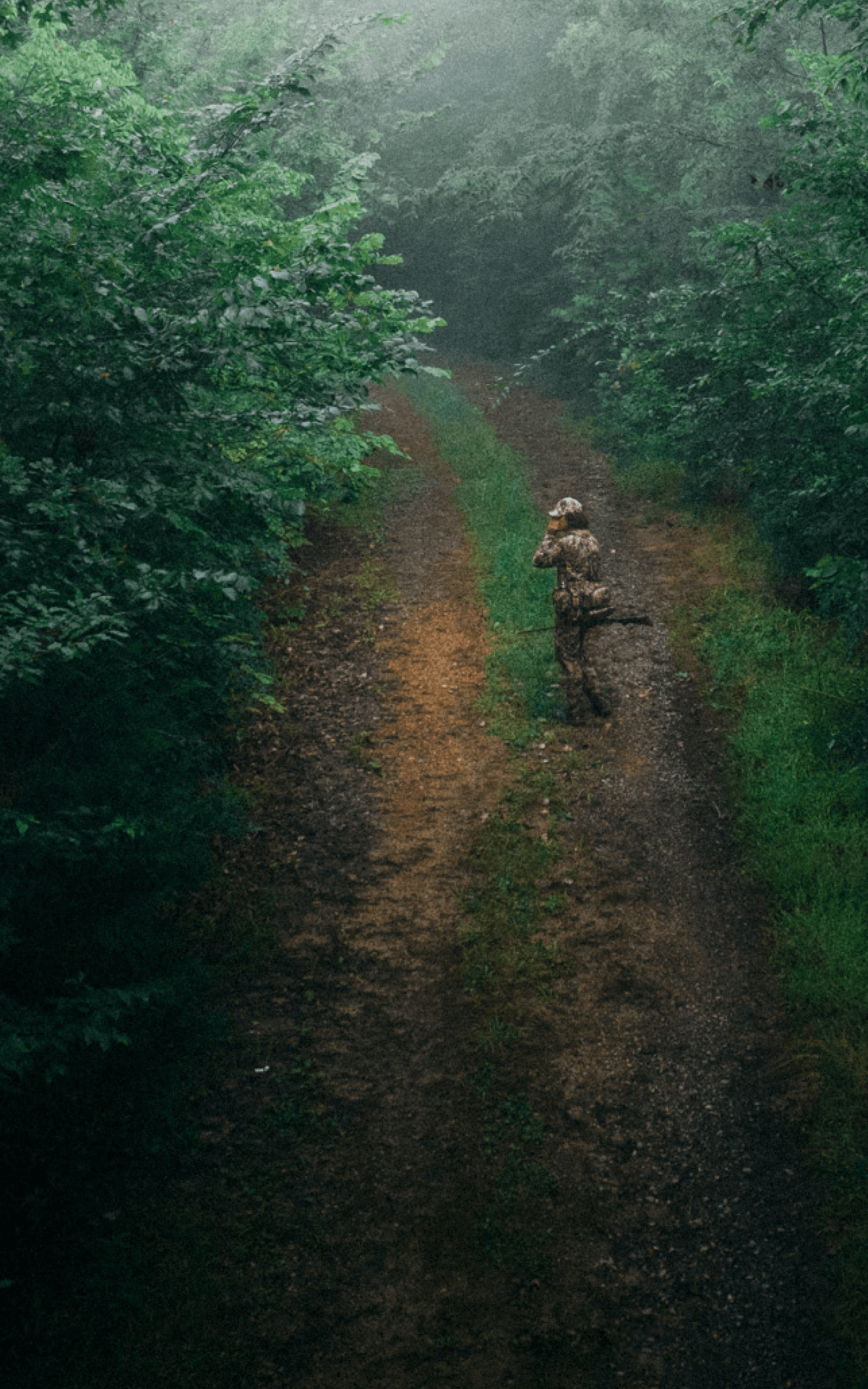 Beau Brooks walking down a dirt road turkey calling with the Turkey Tool Belt | SITKA Gear