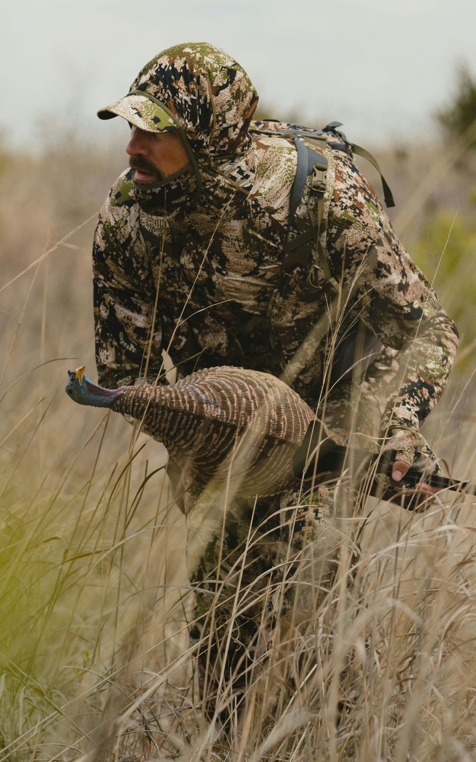 Man in the Equinox Guard System in Optifade Subalpine stalking throught the high grass after Turkey | SITKA Gear
