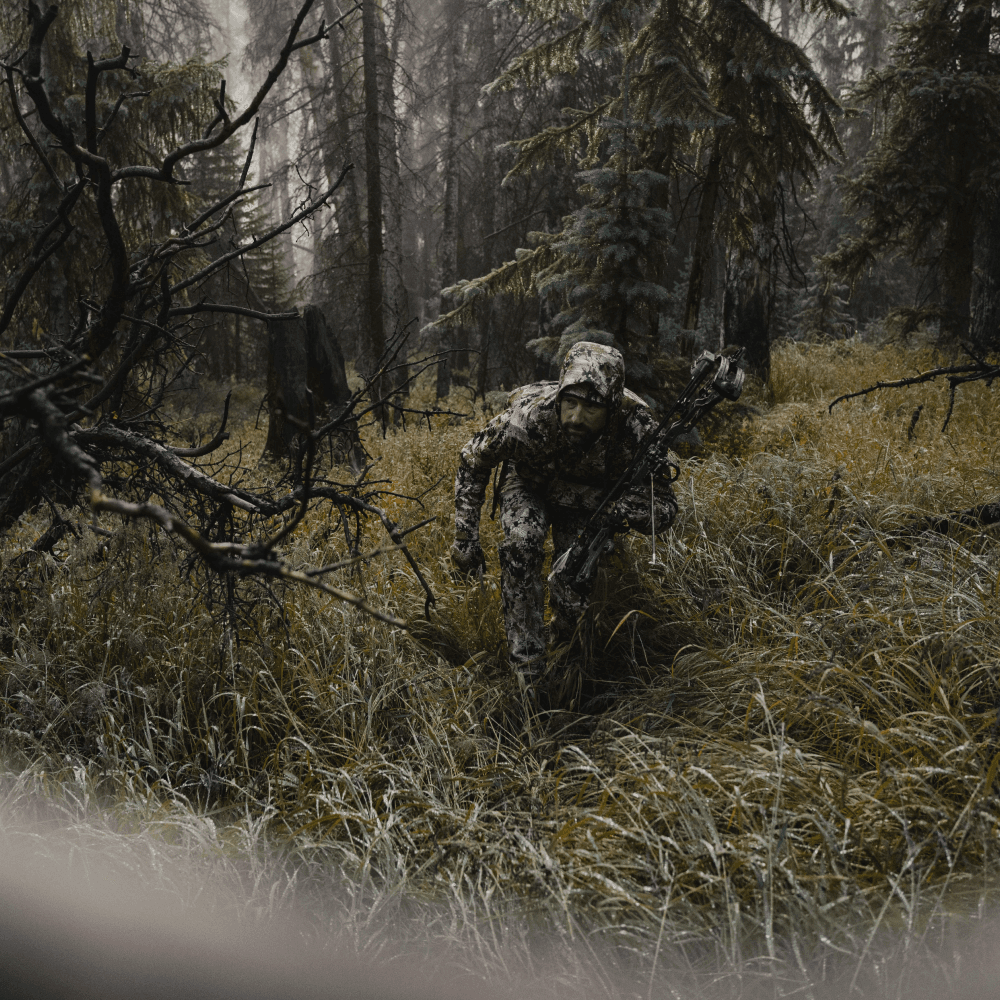 Man in Optifade Subalpine elk hunting staling in vegetated terrain | SITKA Gear