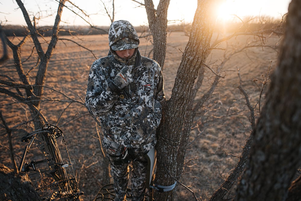 Man braving the wind in a treestand in the Stratus Collection in Optifade Elevated II | SITKA Gear