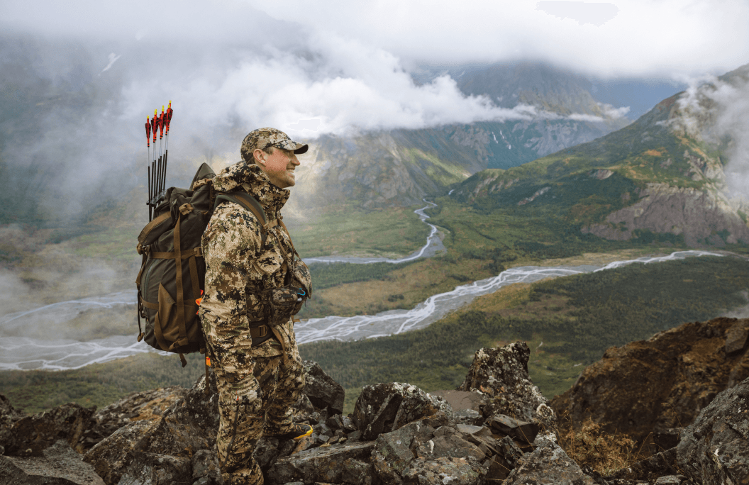 Man on mountain smiling | SITKA Gear